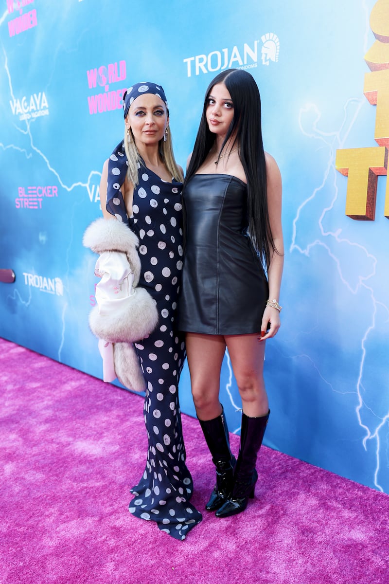 Nicole Richie and Kate Madden pose on the pink carpet in contrasting outfits at the “Stop! That! Train!” world premiere in 2026.