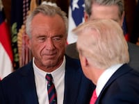 WASHINGTON, DC - NOVEMBER 13: President Donald Trump, shakes hands with Health and Human Services Secretary Robert F. Kennedy Jr. alongside Secretary of Housing and Urban Development Scott Turner (L) after Trump signed the "Fostering the Future" executive order the East Room of the White House on November 13, 2025 in Washington, DC. The executive order, championed by first lady Melania Trump, works to expand opportunities for education, career development, housing and other resources for youth transitioning from foster care to adulthood. (Photo by Heather Diehl/Getty Images)