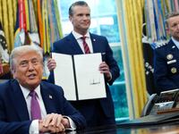 President Donald Trump speaks to the media after signing an executive order renaming the Department of Defense to the Department of War as U.S. Defense Secretary Pete Hegseth and Chairman of the Joint Chiefs of Staff Air Force Gen. Dan Caine look on.
