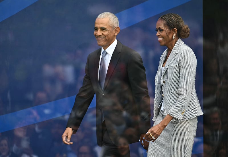 TOPSHOT - Fomer US president Barack Obama and his wife Michelle Obama arrive at the opening of the Barack Obama Presidential Center in Chicago, Illinois, on June 18, 2026. (Photo by Kent NISHIMURA / AFP via Getty Images)