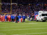 The Buffalo Bills watch running back Damien Harris (22), who was injured on the previous play against the New York Giants, being put into an ambulance.