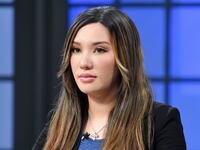Lauren Chen stares forward on a TV set.