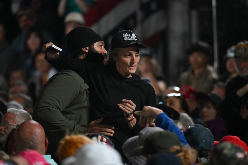 A security officer escorts out a protestor as US President Donald Trump speaks at a midterm campaign rally at Pitt-Greenville Airport in Greenville, North Carolina, on October 20, 2026. (Photo by Kent NISHIMURA / AFP via Getty Images)