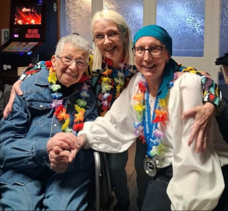 Kim Oakhill poses with friends in a photo on her fundraising website.