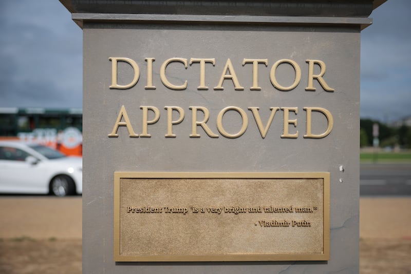 A plaque on the "Dictator Approved" statue shows a quote from Vladimir Putin: "President Trump is a very bright and talented man."