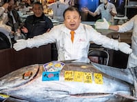 Kiyoshi Kimura (C), president of Kiyomura Corp., the Tokyo-based operator of sushi restaurant chain Sushizanmai, displays a 243-kilogram bluefin tuna at his main restaurant in Tokyo on January 5, 2026, after the New Year's auction at Toyosu fish market. A Japanese sushi entrepreneur paid a record $3.2 million for a giant bluefin tuna January 5 at an annual prestigious new year auction in Tokyo's main fish market, smashing the previous all-time high. (Photo by Yuichi YAMAZAKI / AFP via Getty Images)