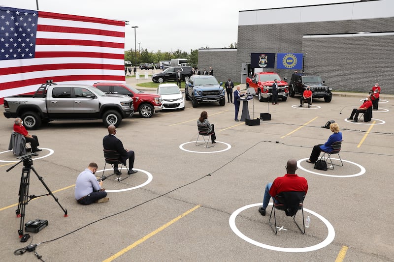 Joe Biden speaking at a September 2020 campaign event where attendees were socially distanced using circles on the ground.