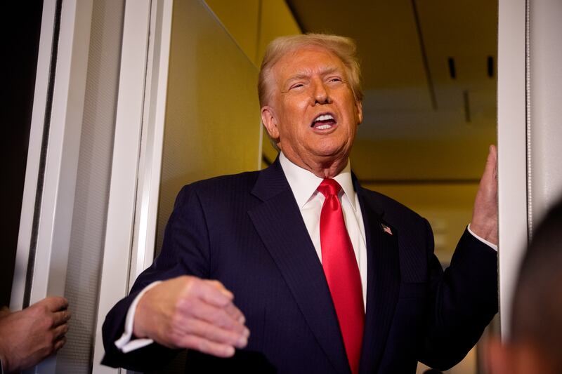 President Donald Trump speaks to members of the media aboard Air Force One on October 30, 2025 in flight.
