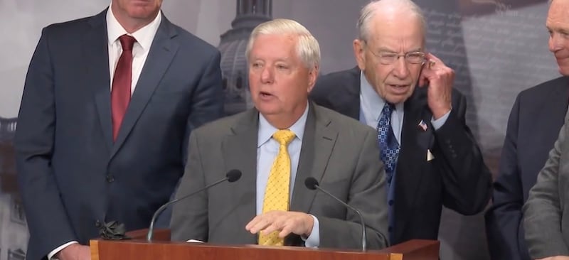 Chuck Grassley tests his hearing at a Senate press conference.