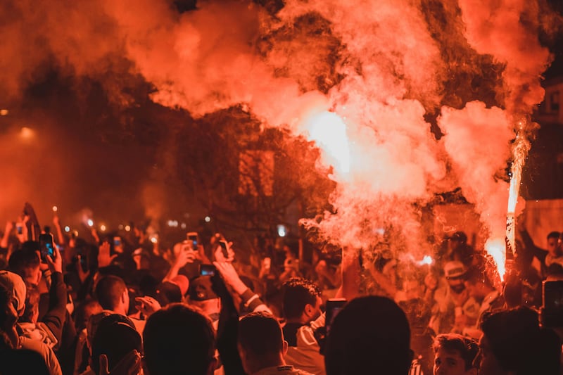 A protest with flares held aloft
