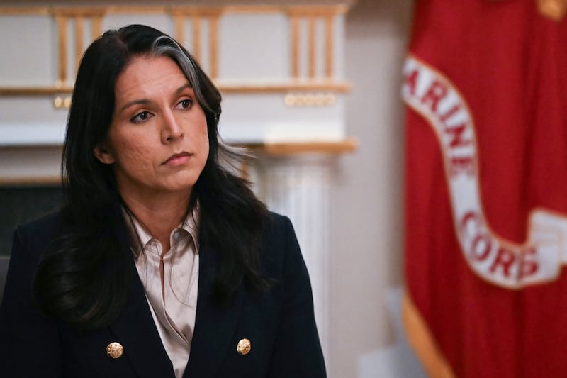 US Director of National Intelligence Tulsi Gabbard listens as President Donald Trump speaks