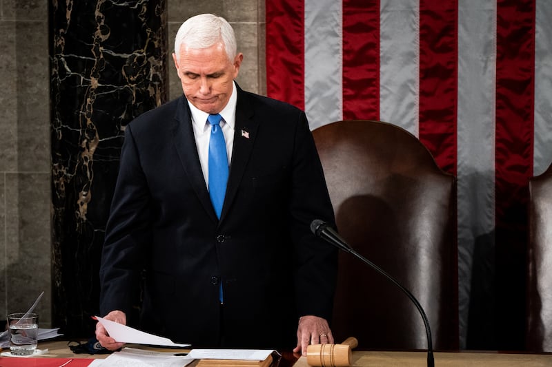 WASHINGTON, DC - JANUARY 06: U.S. Vice President Mike Pence presides over a joint session of Congress to certify the 2020 Electoral College results on January 6, 2021 in Washington, DC. Congress held a joint session today to ratify President-elect Joe Biden's 306-232 Electoral College win over President Donald Trump. A group of Republican senators said they would reject the Electoral College votes of several states unless Congress appointed a commission to audit the election results. (Photo by Erin Schaff-Pool/Getty Images)