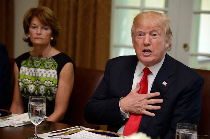 President Donald Trump hosts a working lunch with members of Congress, including Alaska Sen. Lisa Murkowski (L) at the White House, June 13, 2017, in Washington, DC.