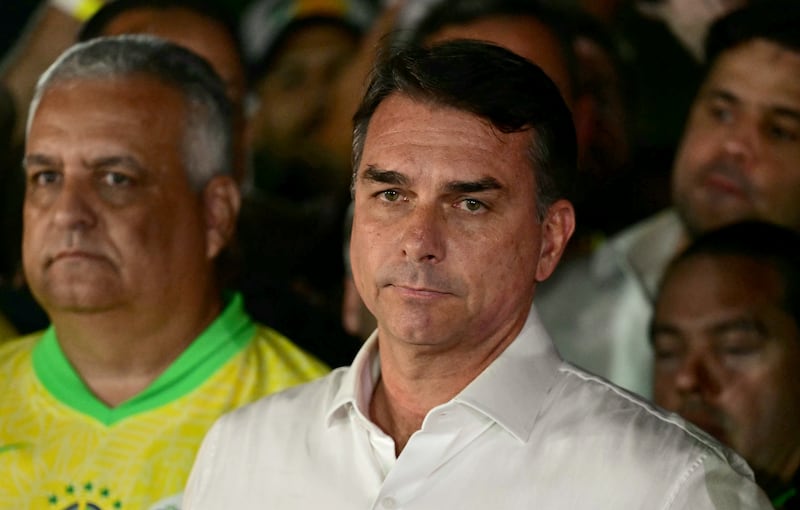Brazil's right-wing senator and presidential candidate for the Liberal Party (PL) Flavio Bolsonaro reacts after knowing the first results in the presidential runoff election, in Brasilia, on October 25, 2026. Brazil's President and re-election candidate for the Workers' Party (PT) Luiz Inacio Lula da Silva pulled off a dramatic comeback on October 25, 2026, as he clinched election victory against right-wing senator Flavio Bolsonaro, who trounced him in the first round. (Photo by Pablo PORCIUNCULA / AFP via Getty Images)