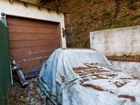 Jesuit statue and a covered vehicle sit in the driveway below a home where authorities are investigating a residential fire which took the life of eccentric millionaire Will Rothschild on November 28, 2024 in Hollywood Hills California. The fire began on Wednesday evening.