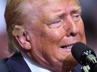Republican presidential nominee and former U.S. President Donald Trump wears a flesh-colored bandage on his ear as he holds a campaign rally for the first time with his running mate.