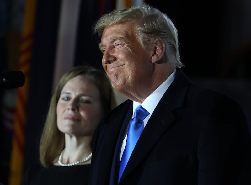 President Donald Trump stands next to Amy Coney Barrett before her ceremonial swearing-in for the position of the U.S. Supreme Court Associate Justice on the South Lawn of the White House October 26, 2020 in Washington, DC.