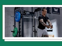 A man working out with an all-in-one workout machine.