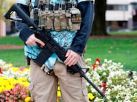 A photo of an armed Boogaloo Boi in a Hawaiian shirt.