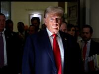 Donald Trump looks on during a break at a Manhattan courthouse as he attends trial in a civil fraud case