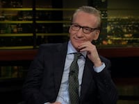 Real Time host Bill Maher sits on set of his HBO tv show.