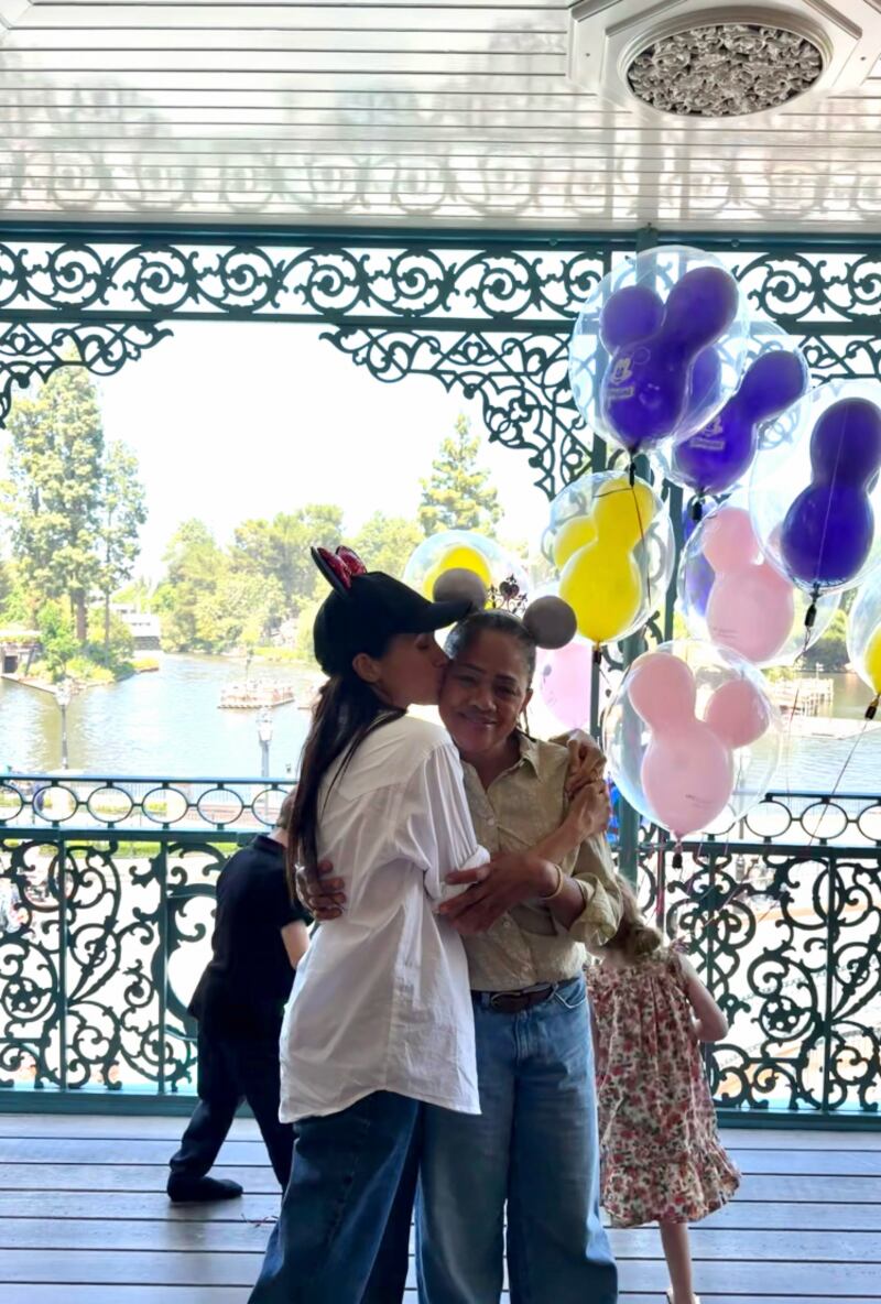 Meghan Markle is pictured kissing her mother, Dora Ragland, in the May 11 Instagram post in Disneyland.