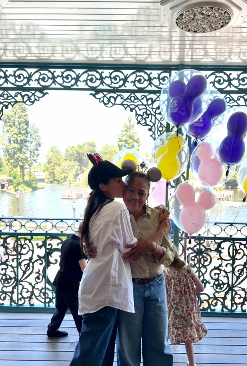 Meghan Markle is pictured kissing her mother, Dora Ragland, in the May 11 Instagram post in Disneyland.