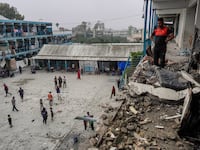 Palestinians check a UN-school housing displaced people that was hit during Israeli bombardment in Nuseirat, in the central Gaza Strip, on June 6, 2024.