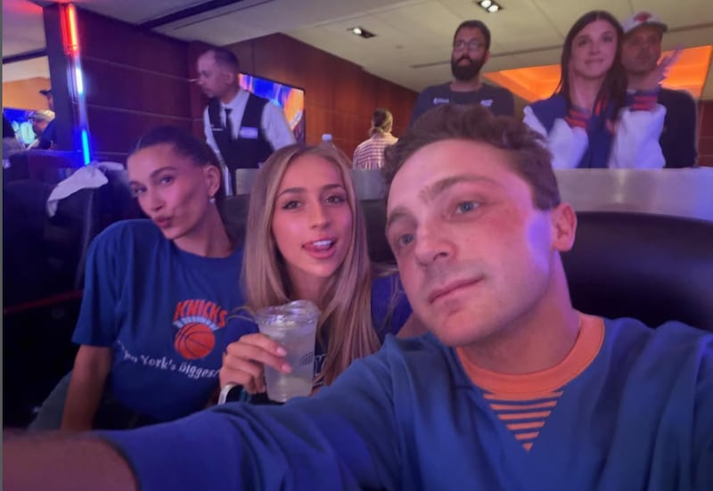 Comedian Jake Shane poses in a selfie at a Knicks game with pop star Tate McRae and Beauty brand owner and influencer Hailey Bieber.