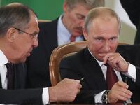 Russia's President Vladimir Putin and Foreign Minister Sergei Lavrov seated at a table.