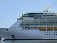 A side view of Liberty of the Seas as the cruise ship sits in port.