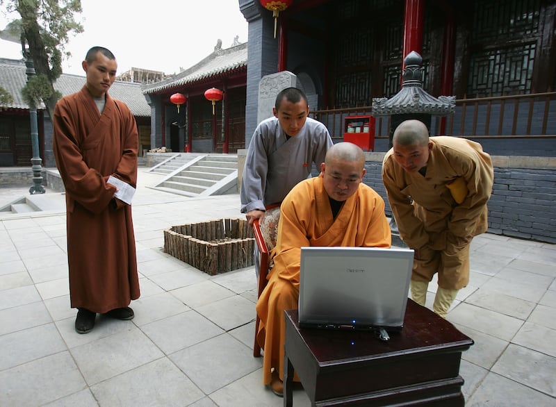 DENGFENG, CHINA - APRIL 8: Shi Yongxin, abbot of the Shaolin Temple, works on the computer April 8, 2005 in Dengfeng, Henan Province, China. Shaolin Temple was built in AD 495 in the period of the Northern and Southern Dynasties (420-581), located in the Songshan Mountain area, and is the birthplace of the Shaolin Kung Fu. Shaolin Kung Fu, with its incredible strength, vitality and flexibility, is expecting to be included in the UNESCO intangible heritage list. Shi Yongxin sends his monks abroad to coach foreign students and has toured around the world lecturing on Buddhism and the Kung Fu spirit of his temple. Yongxin has led his warrior monks to more than 20 countries, including the United States, the United Kingdom and Japan. The Shaolin Temple now has overseas branches in London, Berlin, Budapest and Vienna. (Photo by Cancan Chu/Getty Images)