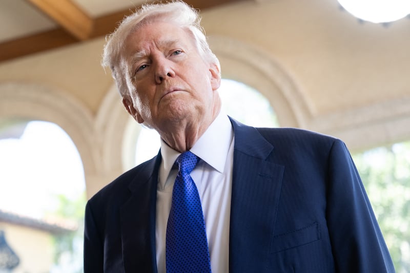 US President Donald Trump speaks to the press as he arrives to attend the wedding of Dan Scavino, White House Deputy Chief of Staff, and Erin Elmore, the Department of State Director of Art in Embassies, at Mar-a-Lago in Palm Beach, Florida, February 1, 2026.
