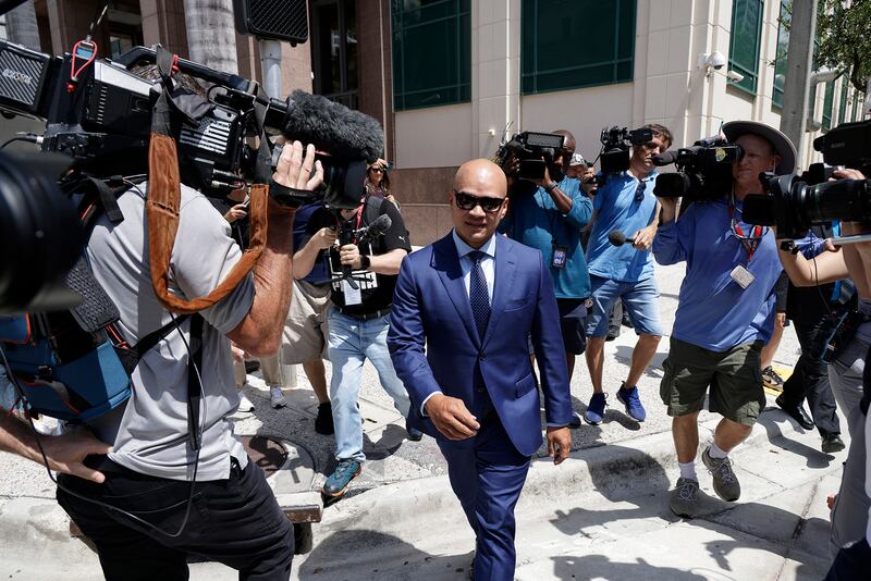 A photo of Walt Nauta, valet of former President Donald Trump, walks by reporters outside federal court in Miami, Florida.