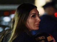 JOINT BASE ANDREWS, MARYLAND - OCTOBER 02: Political activist Laura Loomer follows behind U.S. President Donald Trump as he walks off Air Force One on October 02, 2026 in Joint Base Andrews, Maryland. Trump travelled to Mobile, Alabama for a campaign rally. (Photo by Anna Moneymaker/Getty Images)