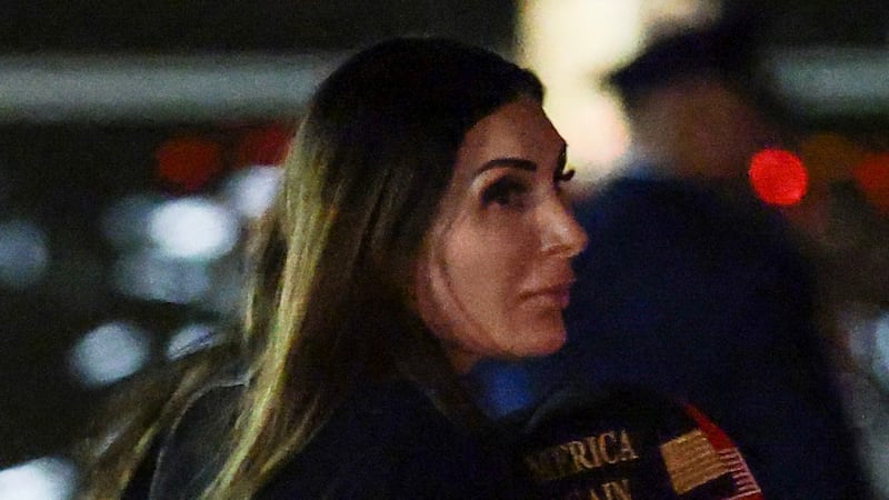 JOINT BASE ANDREWS, MARYLAND - OCTOBER 02: Political activist Laura Loomer follows behind U.S. President Donald Trump as he walks off Air Force One on October 02, 2026 in Joint Base Andrews, Maryland. Trump travelled to Mobile, Alabama for a campaign rally. (Photo by Anna Moneymaker/Getty Images)