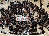 Protesters sit in the middle of the Capitol Rotunda to protest the war between Israel and Hamas.