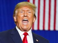 Donald Trump reacts as he attends a rally in Warren, Michigan, Oct. 1, 2022.
