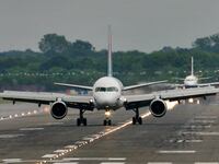 Passenger planes prepare for take off from Gatwick Airport in Sussex.