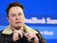 NEW YORK, NEW YORK - NOVEMBER 29: Elon Musk wears a necklace in honor of Israeli hostages onstage during The New York Times Dealbook Summit 2023 at Jazz at Lincoln Center on November 29, 2023 in New York City. (Photo by Slaven Vlasic/Getty Images for The New York Times)