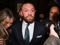 Dublin , Ireland - 22 November 2024; Mr Conor McGregor leaves court, accompanied by his partner Dee Devlin, after the court announced the jury's decision in the civil action case, P Ní Laimhin v McGregor & Anor, in High Court 24 at Chancery Place in Dublin. (Photo By David Fitzgerald/Sportsfile via Getty Images)
