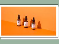 TruSkin vitamin C facial serum bottles arranged on an orange background, showcasing a three-step skincare routine for brightening and anti-aging
