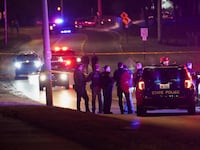 Police officers surround a scene where the suspect was located as they respond to a shooting at Michigan State University in East Lansing, Michigan, U.S., February 14, 2023.