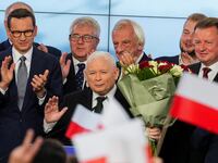 Leader of Poland’s ruling conservative Law and Justice (PiS) party Jaroslaw Kaczynski, holds flowers during a speech after the exit poll results are announced in Warsaw, Poland, Oct. 15, 2023.