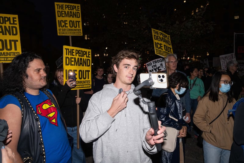 NEW YORK, NEW YORK - OCTOBER 22: Conservative influencer Nick Shirley films protestors demonstrating against U.S. Immigration and Customs Enforcement (ICE) arrests on October 22, 2025 in New York City. Federal agents arrested nine individuals during an operation on Manhattan's Canal Street on Tuesday, targeting undocumented immigrants potentially linked to illegal street vending, according to officials and a senior law enforcement source familiar with the investigation. (Photo by Adam Gray/Getty Images)