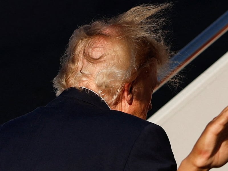 The hair of US President Donald Trump is swept by the wind as he boards Air Force One for a trip to Daytona Beach, Florida, at Joint Base Andrews, Maryland, US, October 30, 2026.
