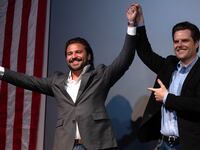 Florida Congressman Matt Gaetz raises Brandon Herrara’s hand after both speak at a rally for Herrara at the Angry Elephant