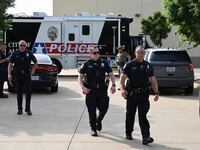 Officers with the Allen Police Department man the mobile command post the day after a gunman shot multiple people at the Dallas-area Allen Premium Outlets mall in Allen, Texas, May 7, 2023.