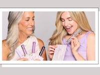 Two women holding Tarte's Lights, Camera, Lashes mascara set, available at QVC