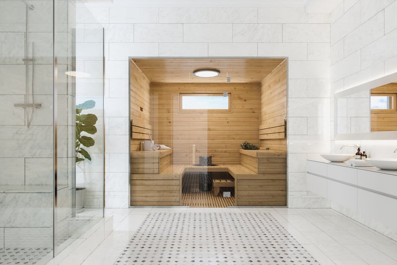 Wooden sauna in a modern, luxurious bathroom.